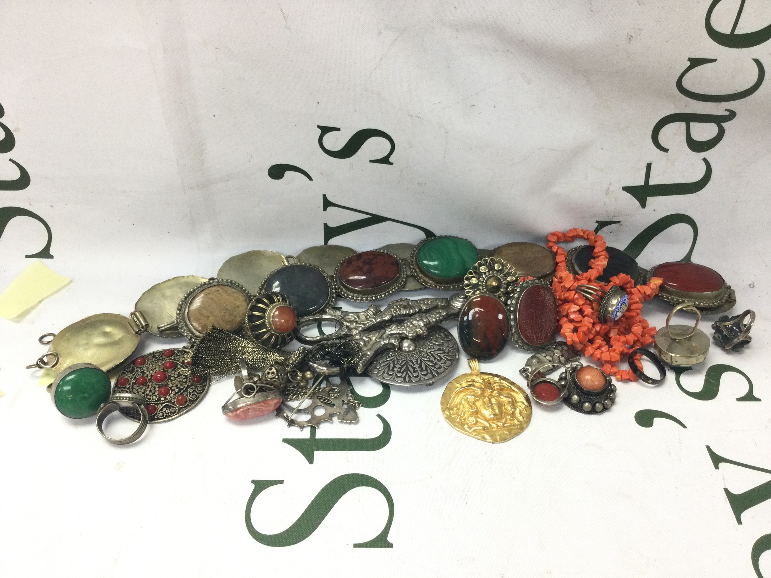 A collection of dress jewellery including a sphinx belt, hard stone belt, etc. 