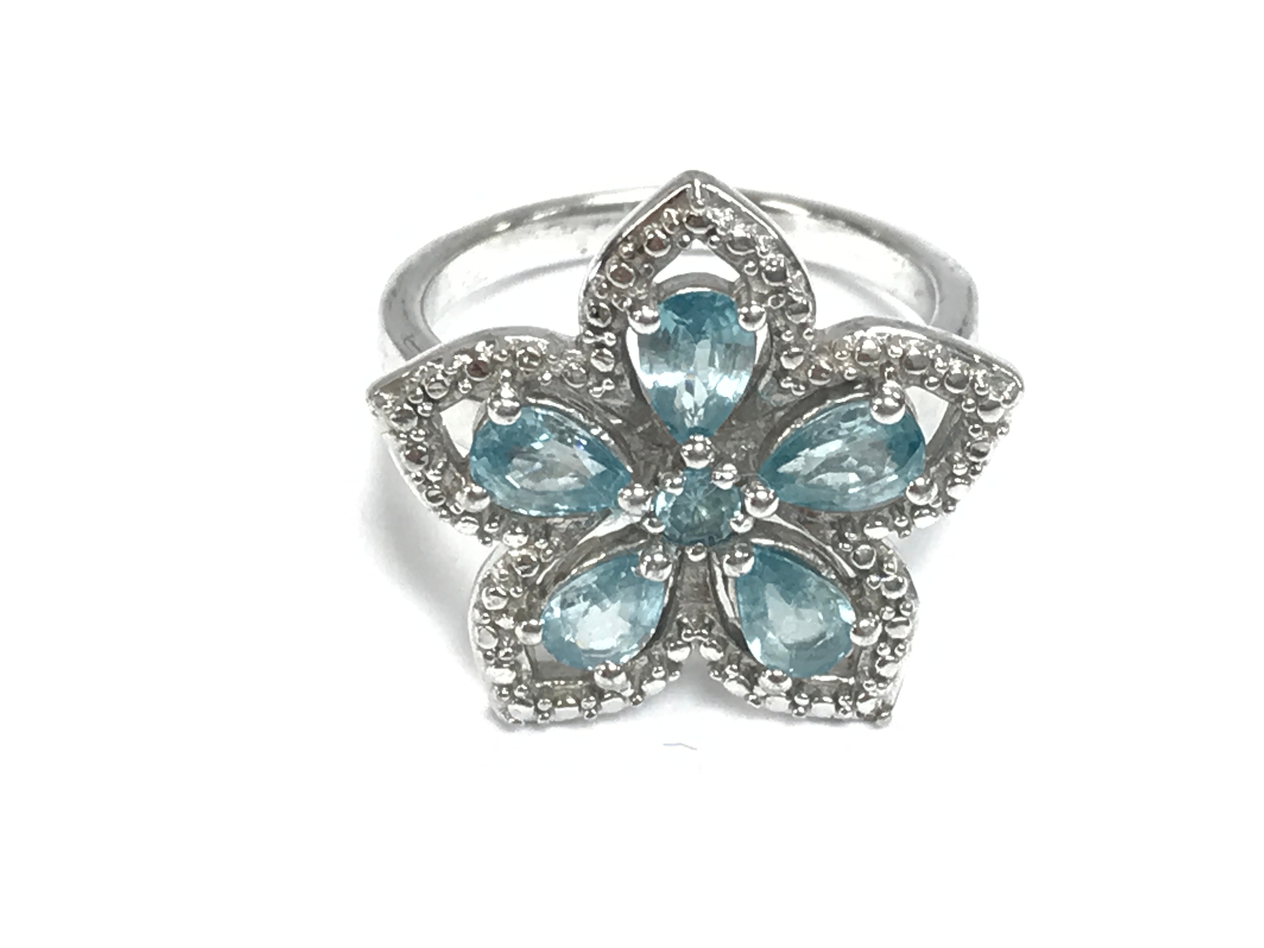 Gold plated silver floral-cluster ring set with blue and white zircon stones. Size R 1/2