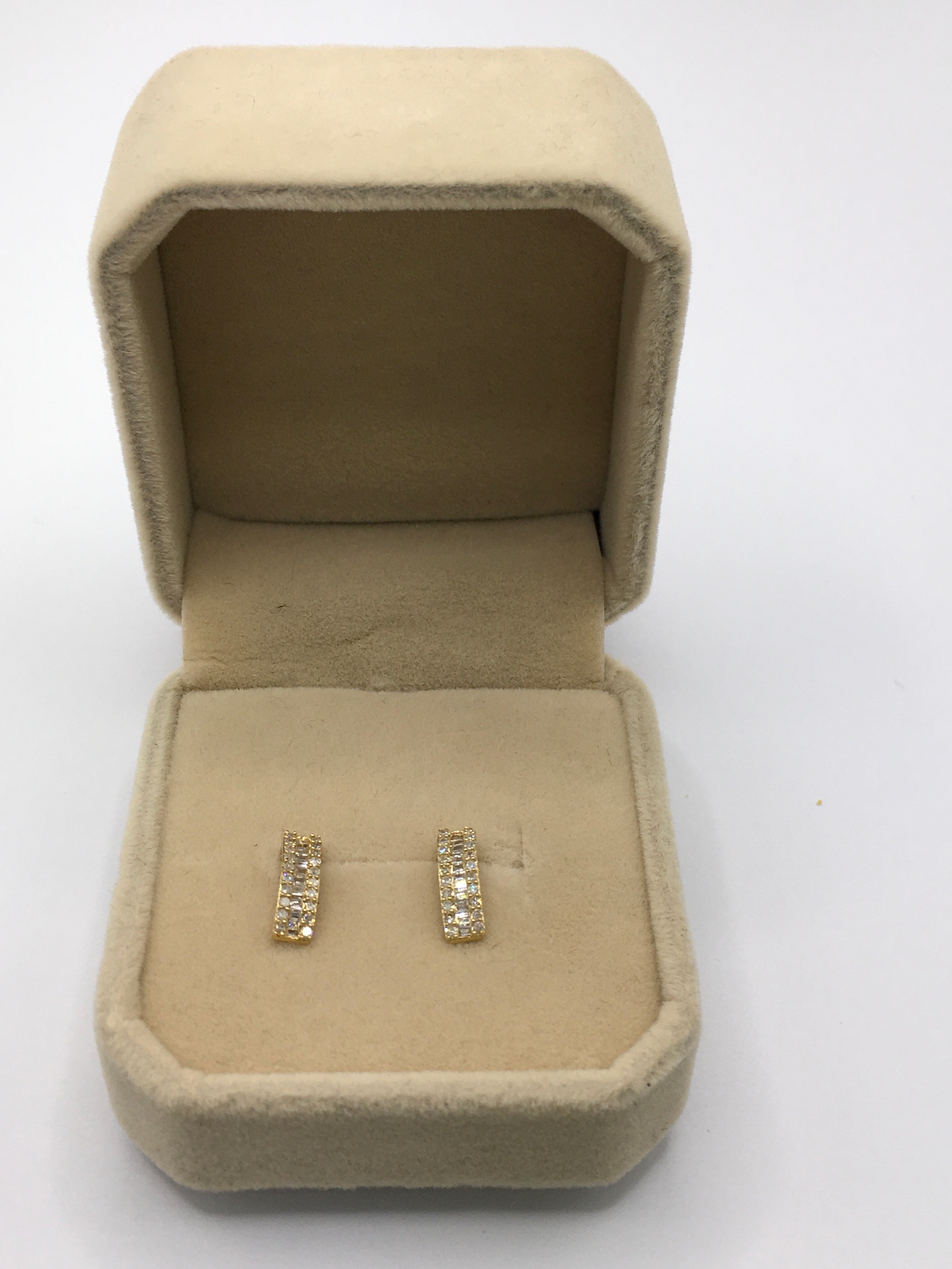 18K yellow gold and 0.30ct diamond set earrings. Round baguettes cut, half loop.1cm long. Boxed with cert.