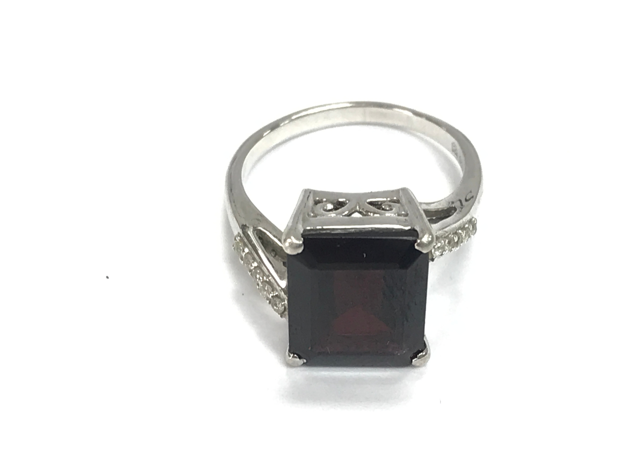 A silver Garnet and white zircon ring. Size N