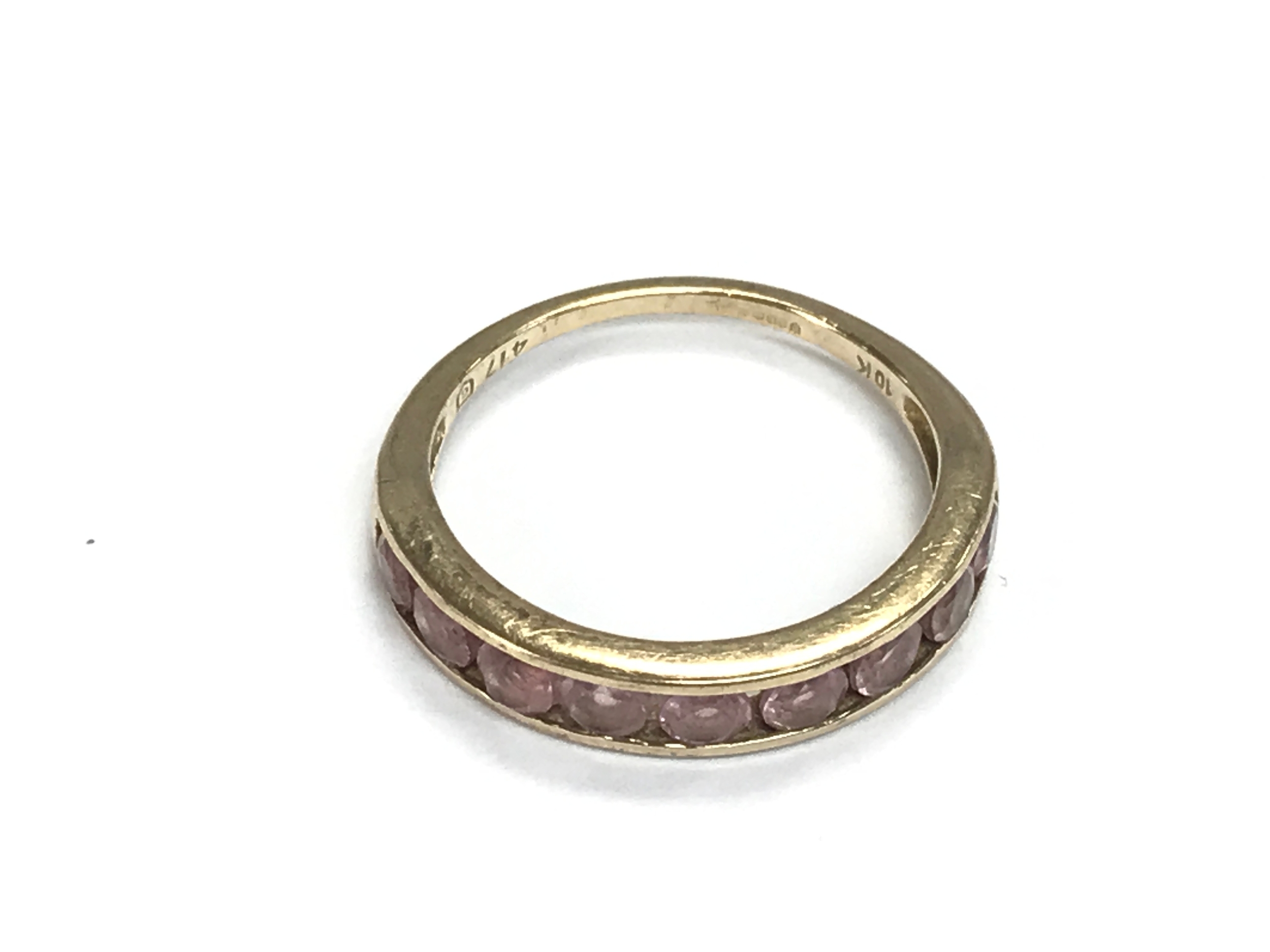 9ct gold half eternity style ring set with pink stones. 2.2g and size N 1/2