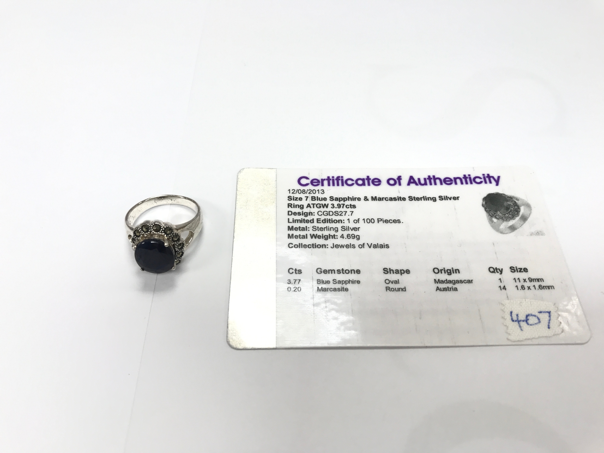 A silver ring set with blue sapphire.