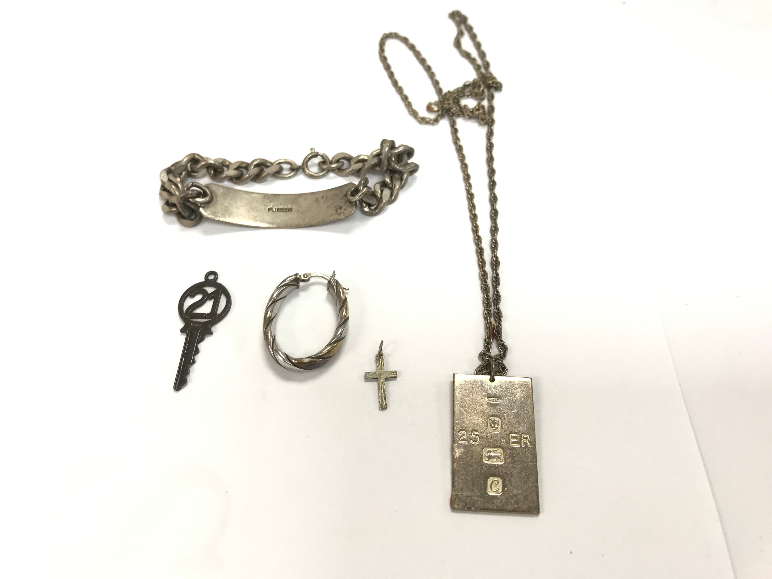 A collection of assorted silver items including ID bracelet. Approximately 45 g
