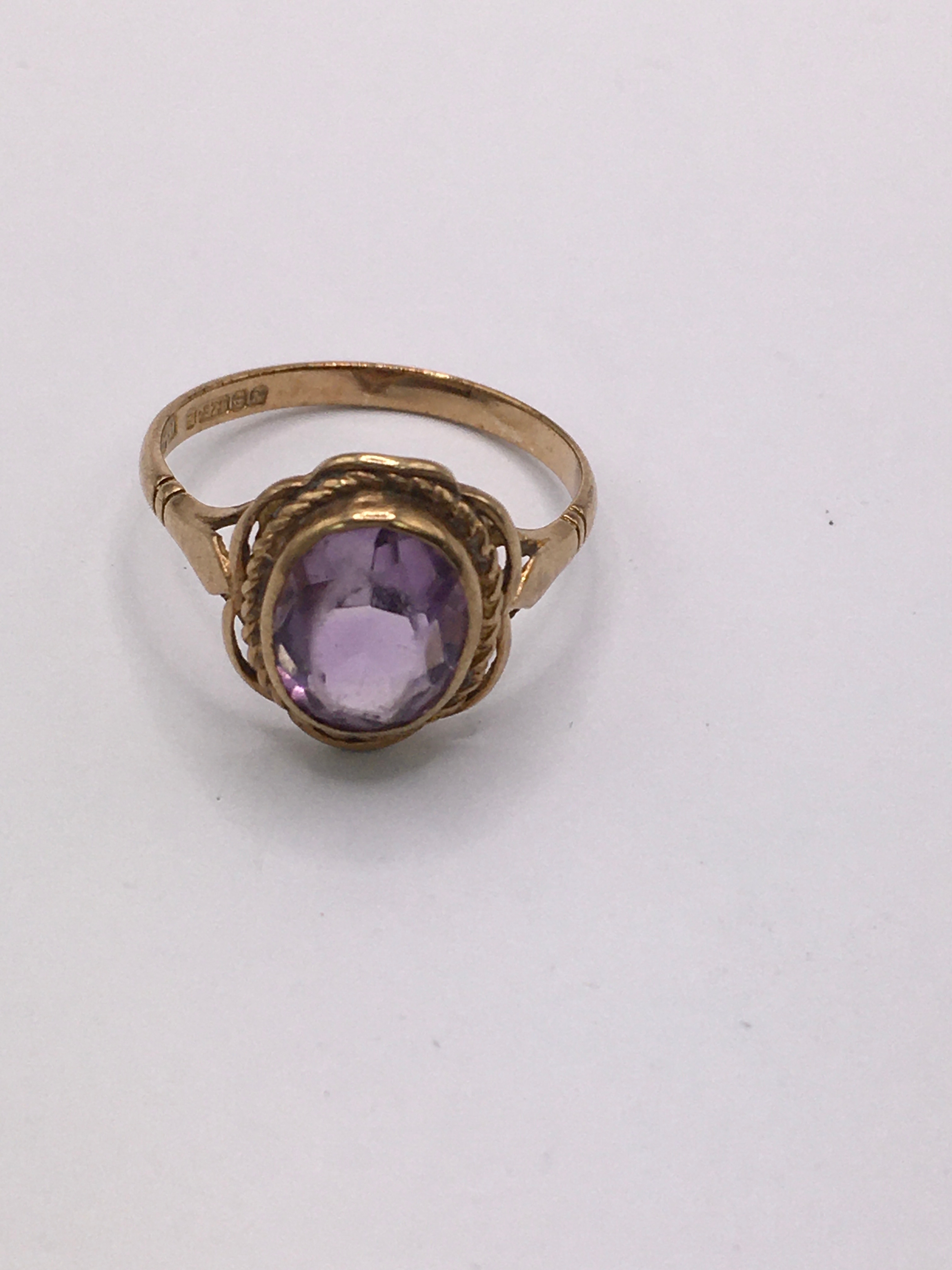 A 9ct gold ring set with an oval amethyst. Size O