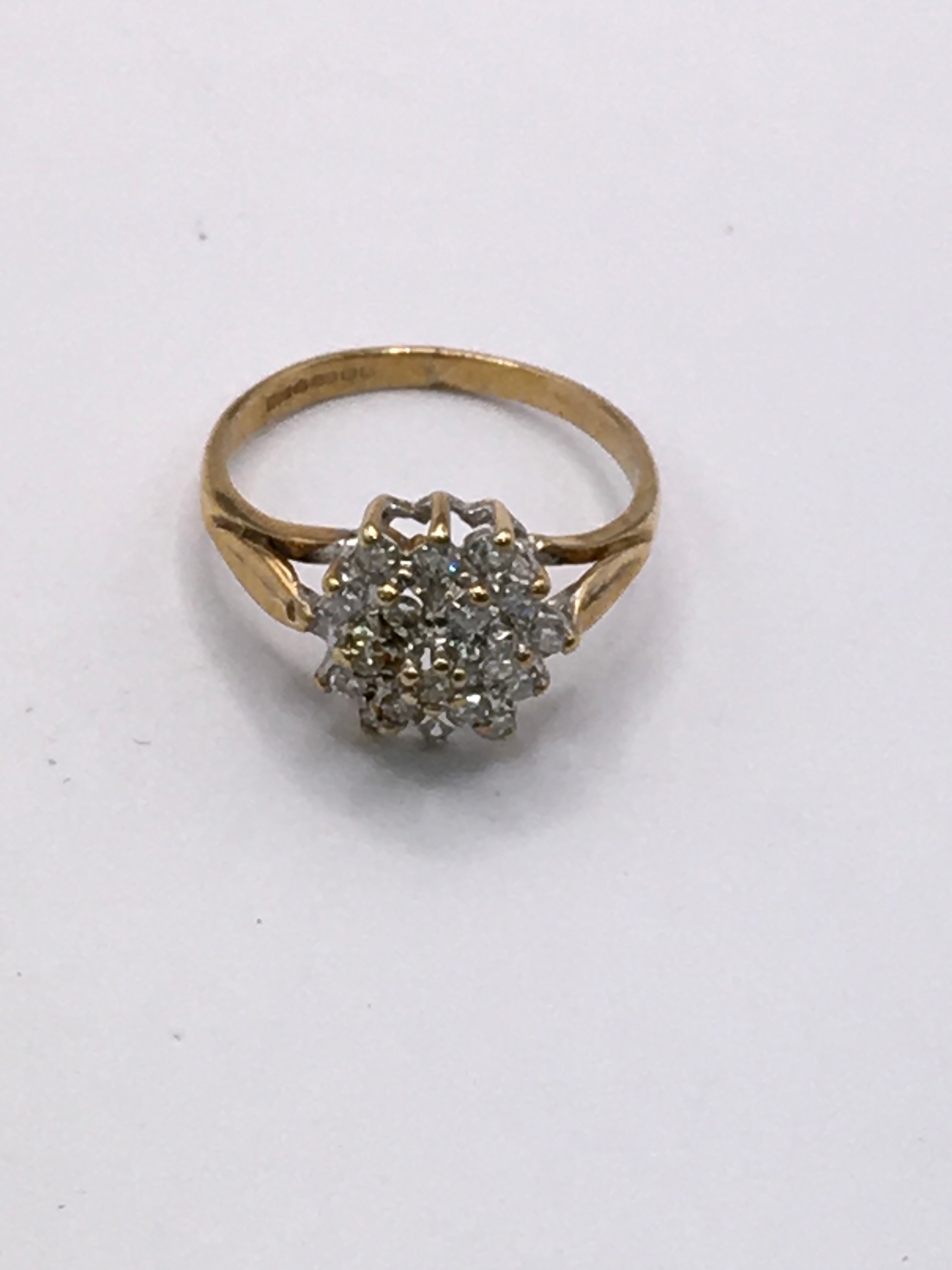 A 9ct gold cluster ring set with white stone. Approx H, small size.