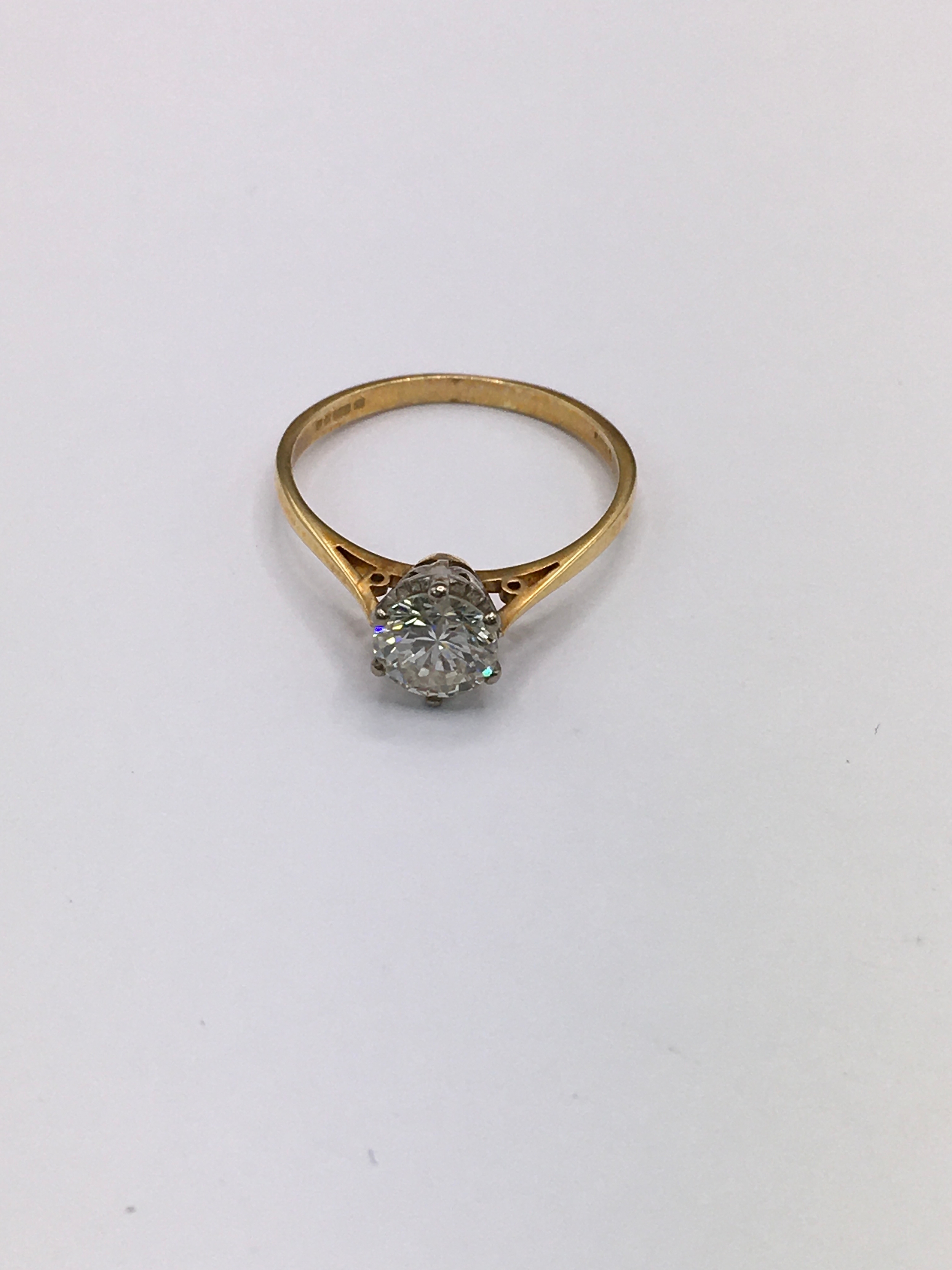 An 18ct gold diamond solitaire ring. Size M