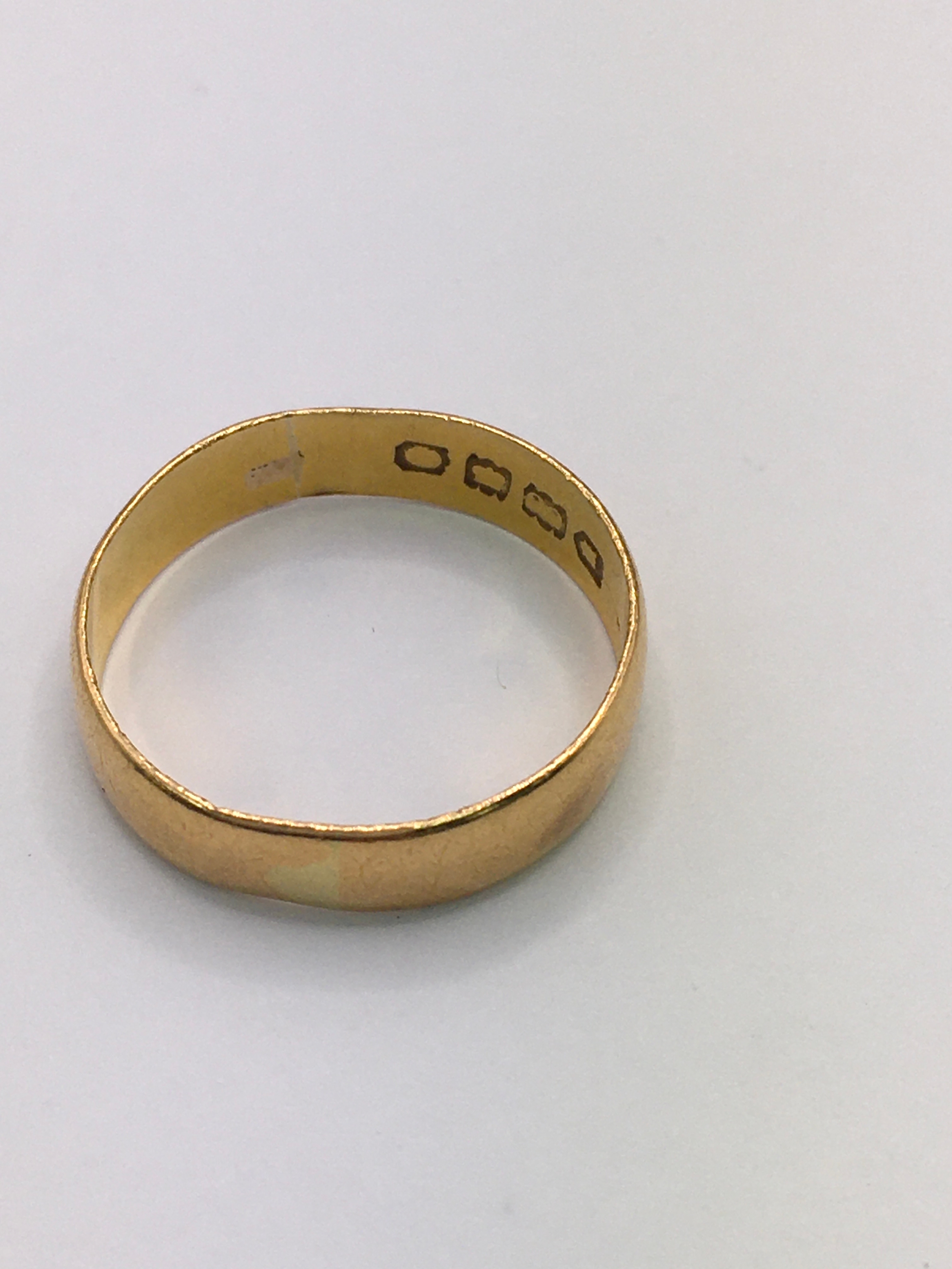 A 22ct gold wedding band of wider fit. Approx size O