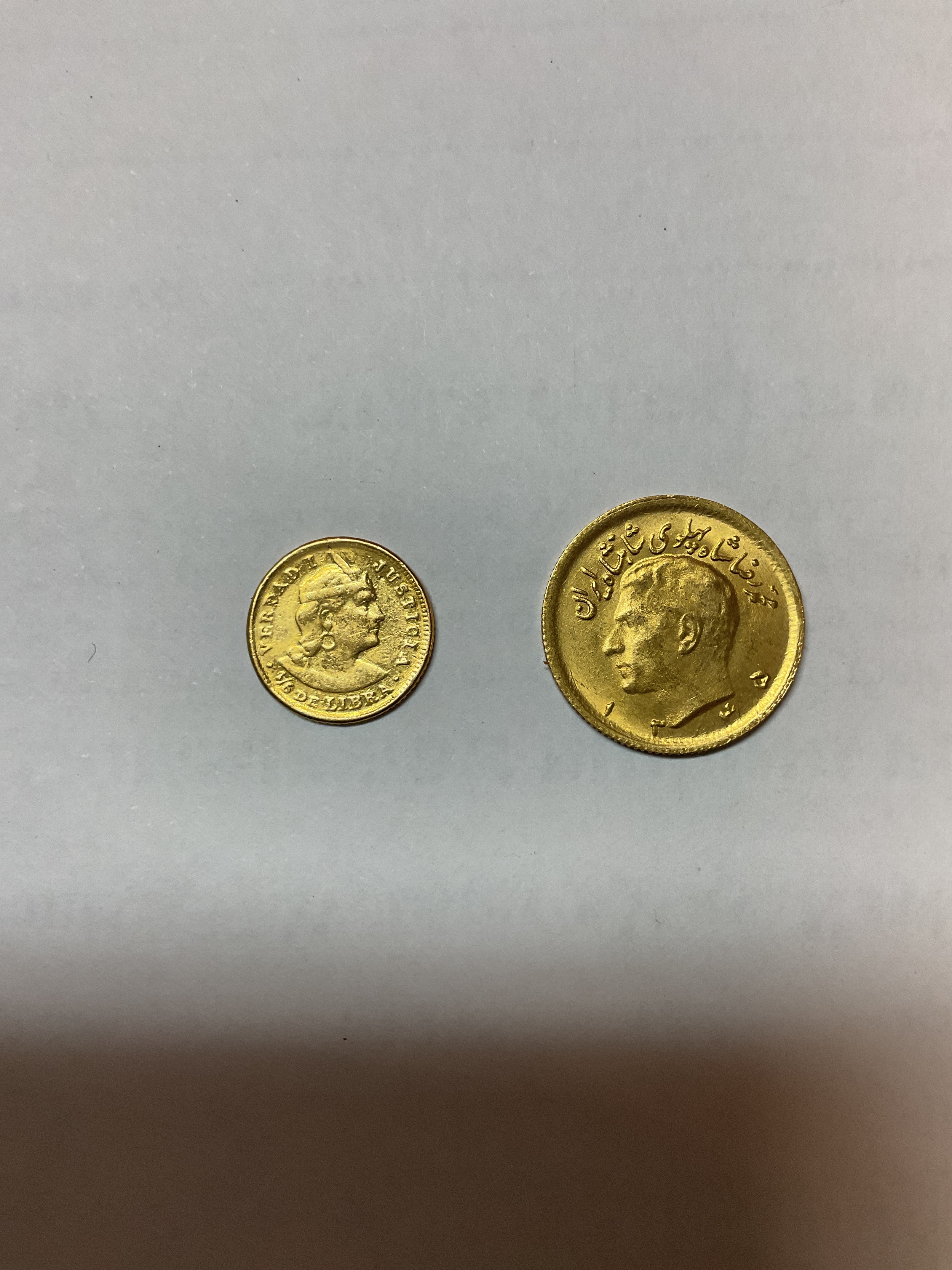 Gold 1906 Peru 1/5th Libra and a Persian Pahlavi weights 4.2 g and 1.5 g.