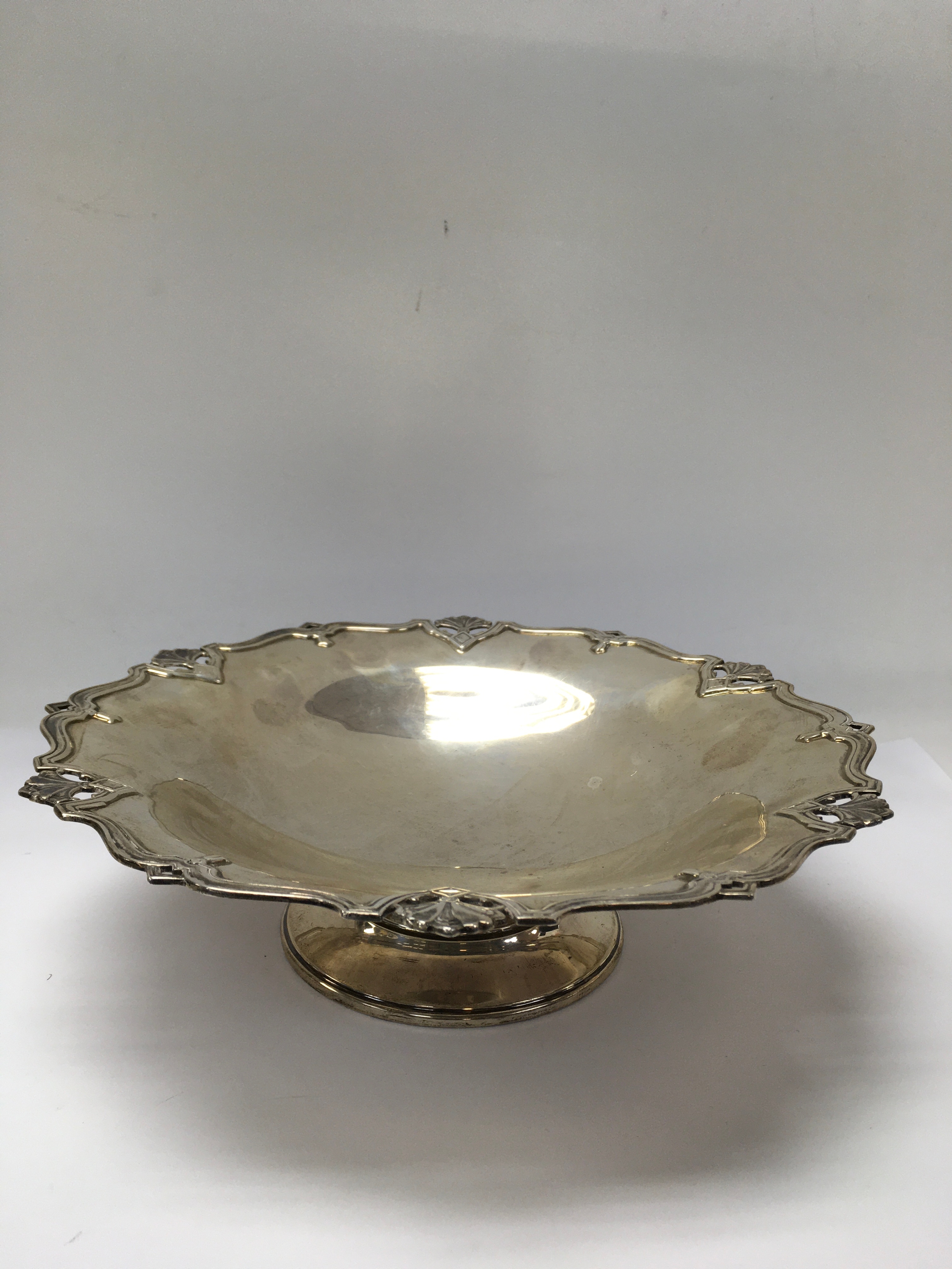 A Mappin & Webb silver tazza dish, having scrolled pierced rim. London hallmarks. Approx 25cm wide.
