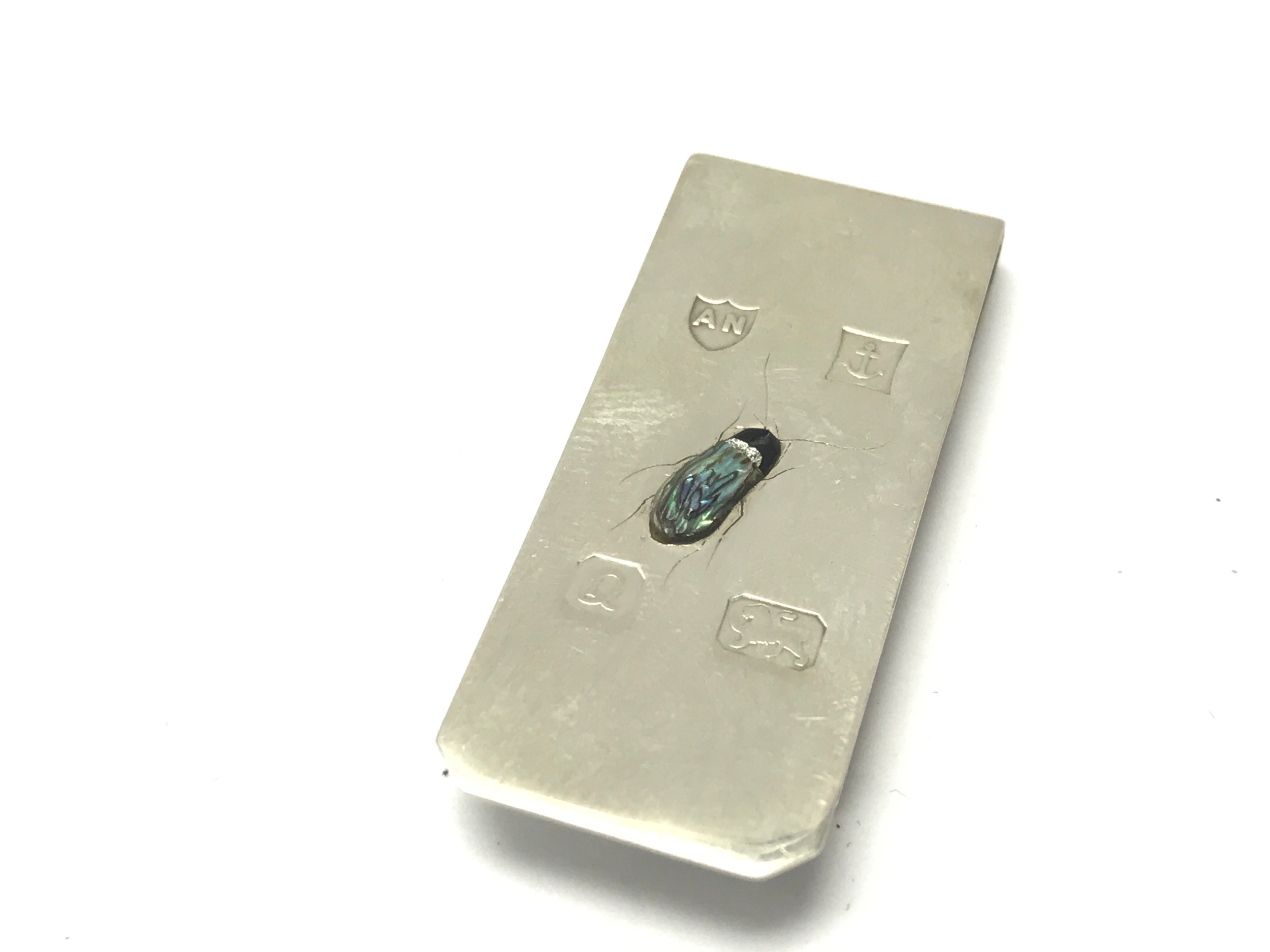 A silver Shibayama money clip.