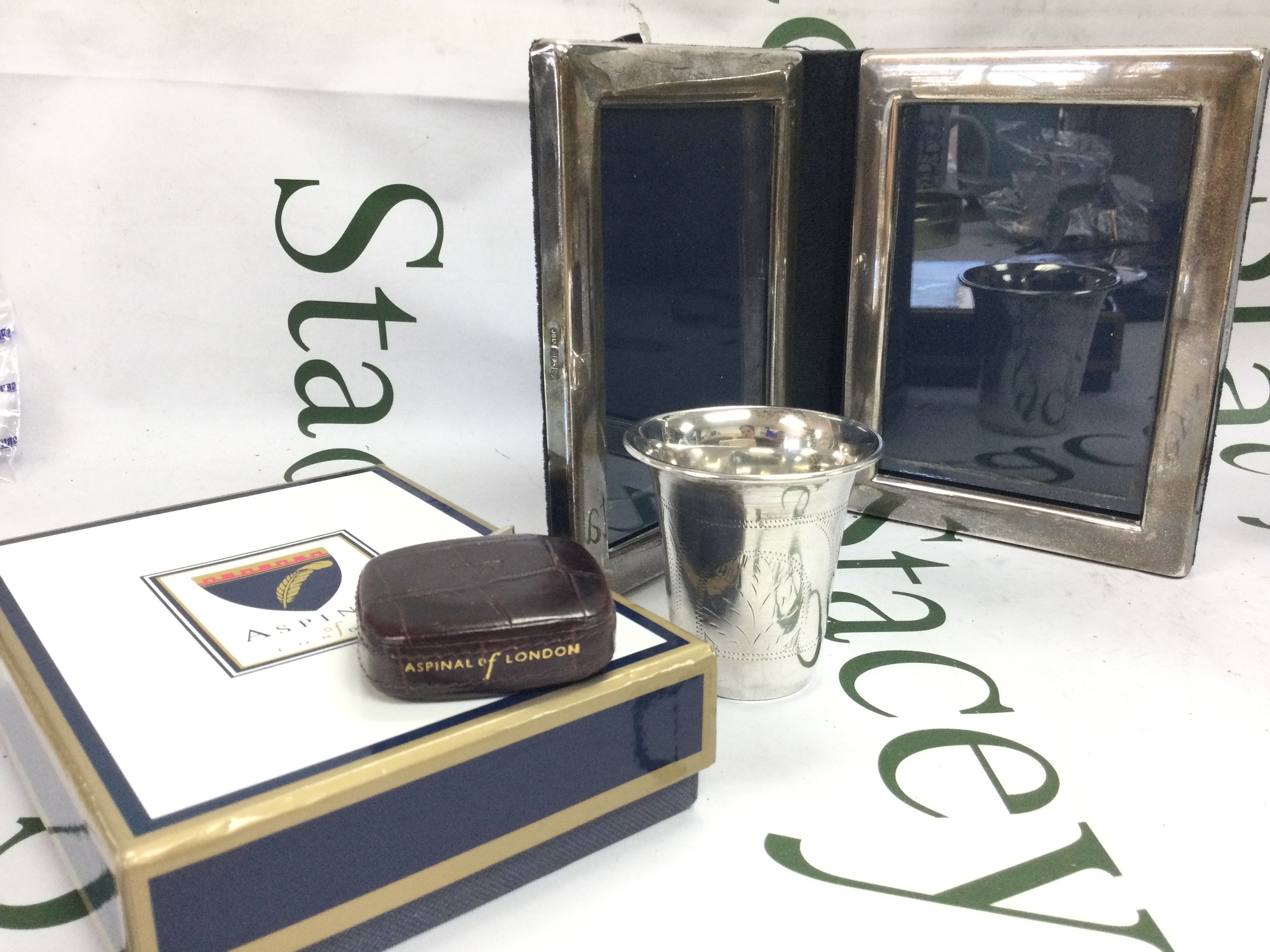 A boxed Aspinal crocodile skin measuring tape, silver hallmarked photo frame 420g (16cm tall, 27cm wide and a silver hallmarked cup 55g (7cm tall).