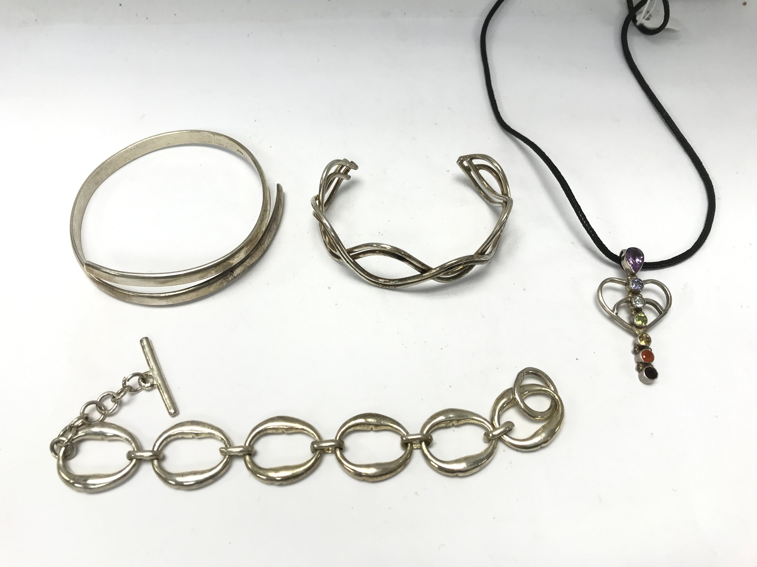 Collection of jewellery items including two silver bangles.