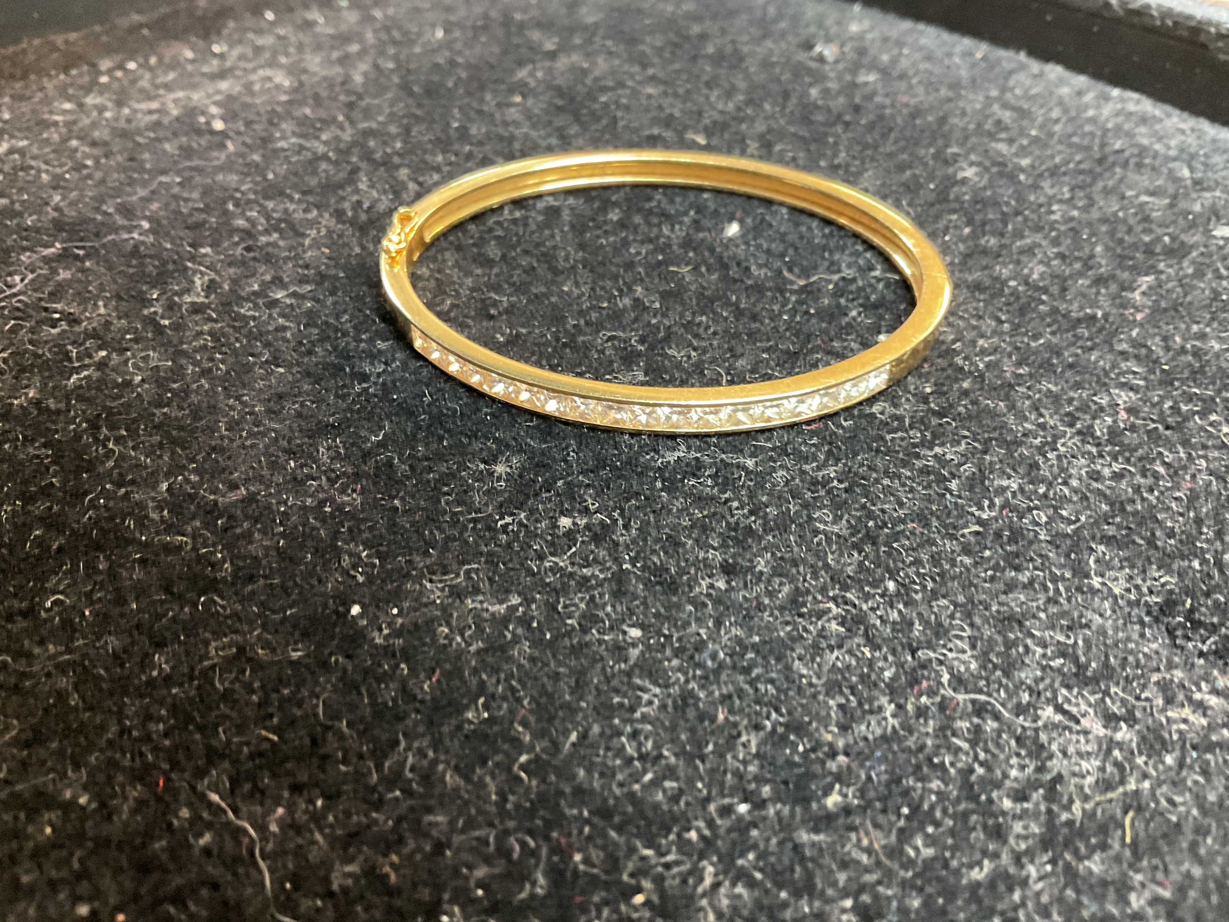 18ct diamond set bangle, with 18 channel set Princess cut diamonds.