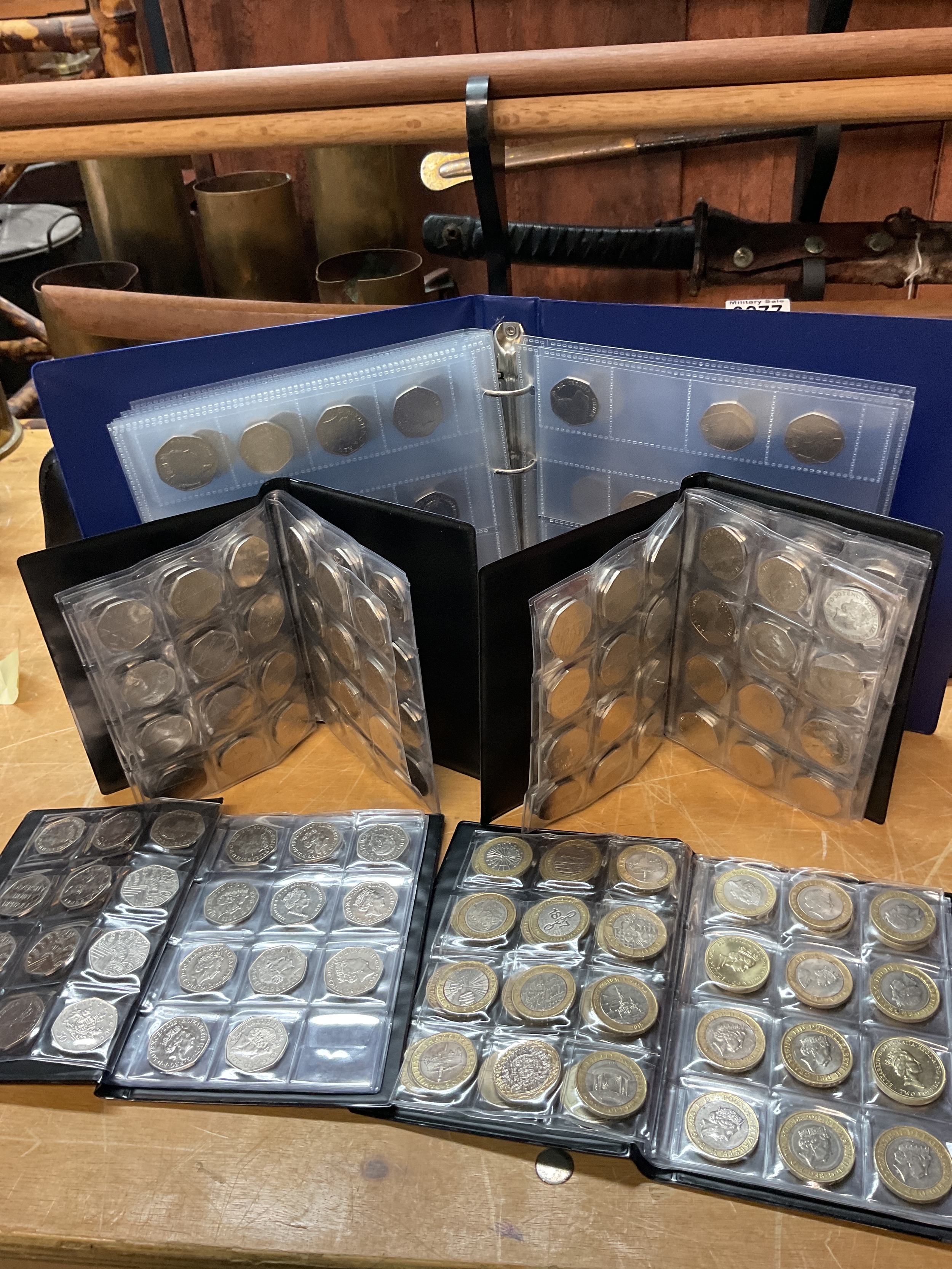 Folders of commemorative 50ps to inc offside rule, and Olympics and many more.and £2 commemoratives.
