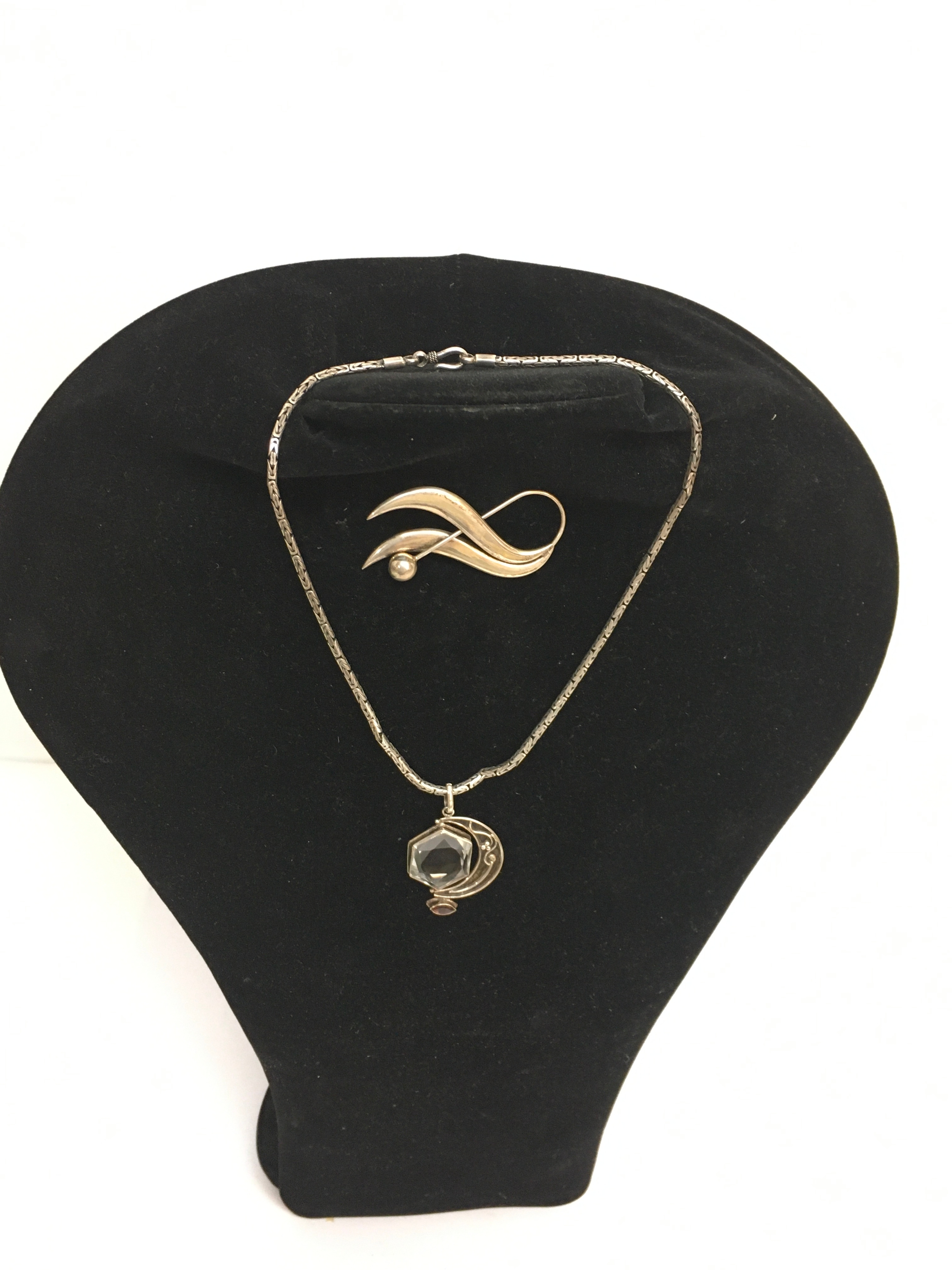 A 925 silver hallmarked brooch of modernist design, and a white metal pendant necklace.5.5 and 23cm long respectively.