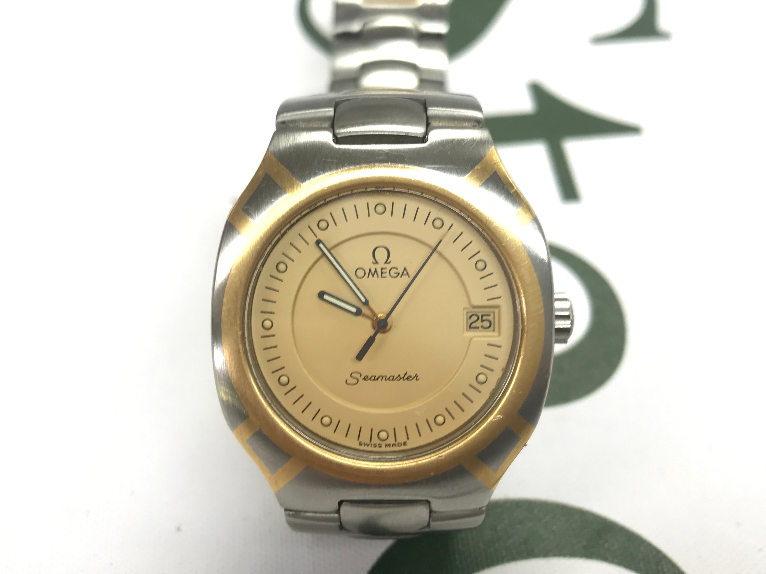 vintage Omega Seamaster Polaris quartz watch featuring a distinctive two-tone stainless steel case and a champagne dial. Seen running.
