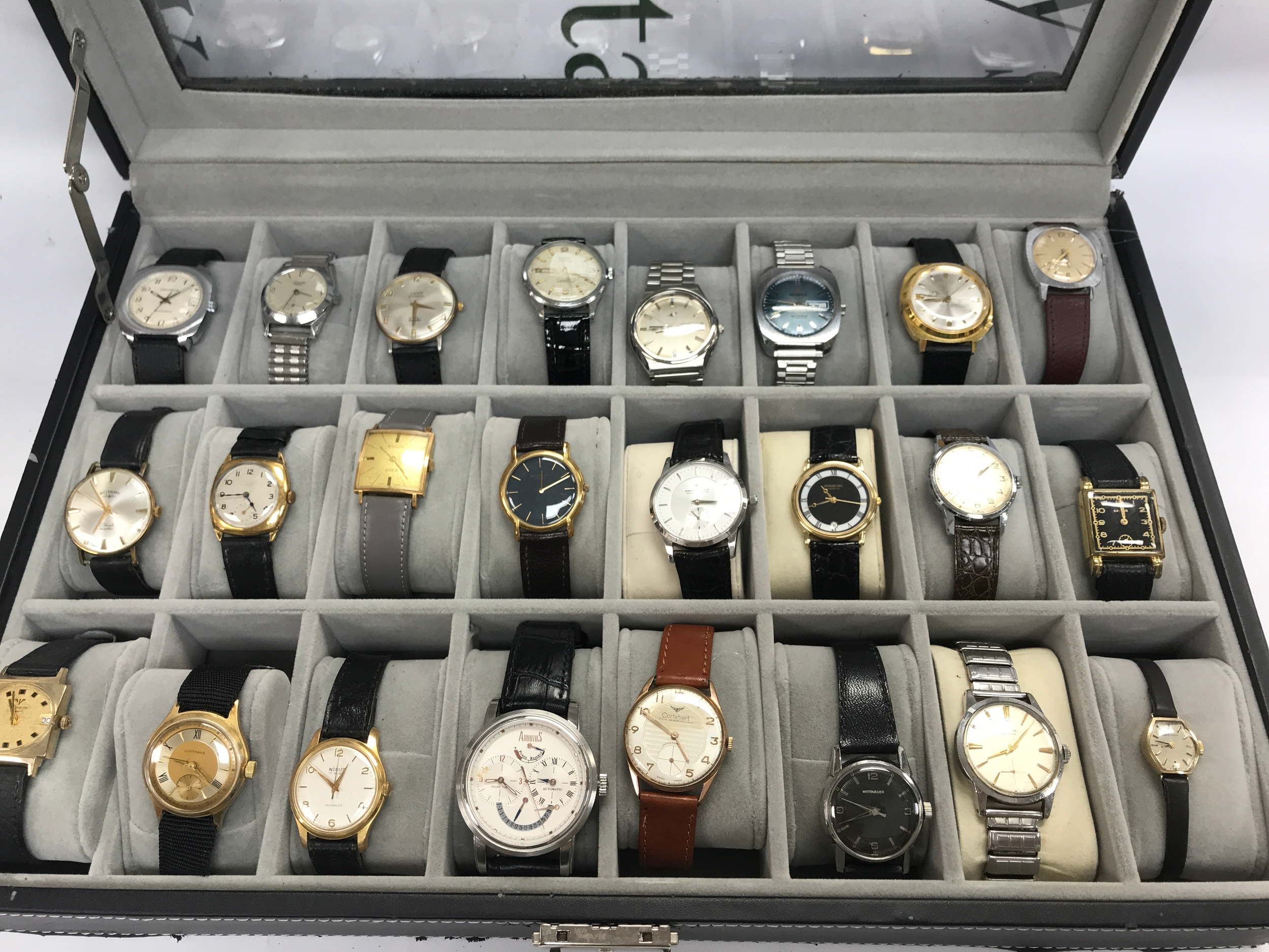 A collection of 24 vintage and dress watches including Rotary and Cortebert and some replica items. Comes with the 24 space watch box.