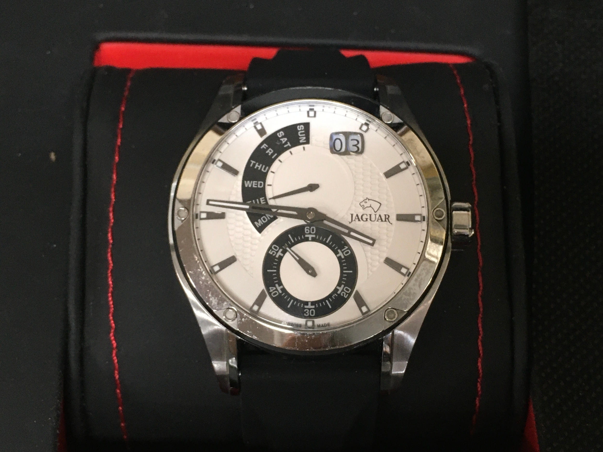 Jaguar Special Edition wristwatch featuring a clean white dial and a black rubber strap. seen running.