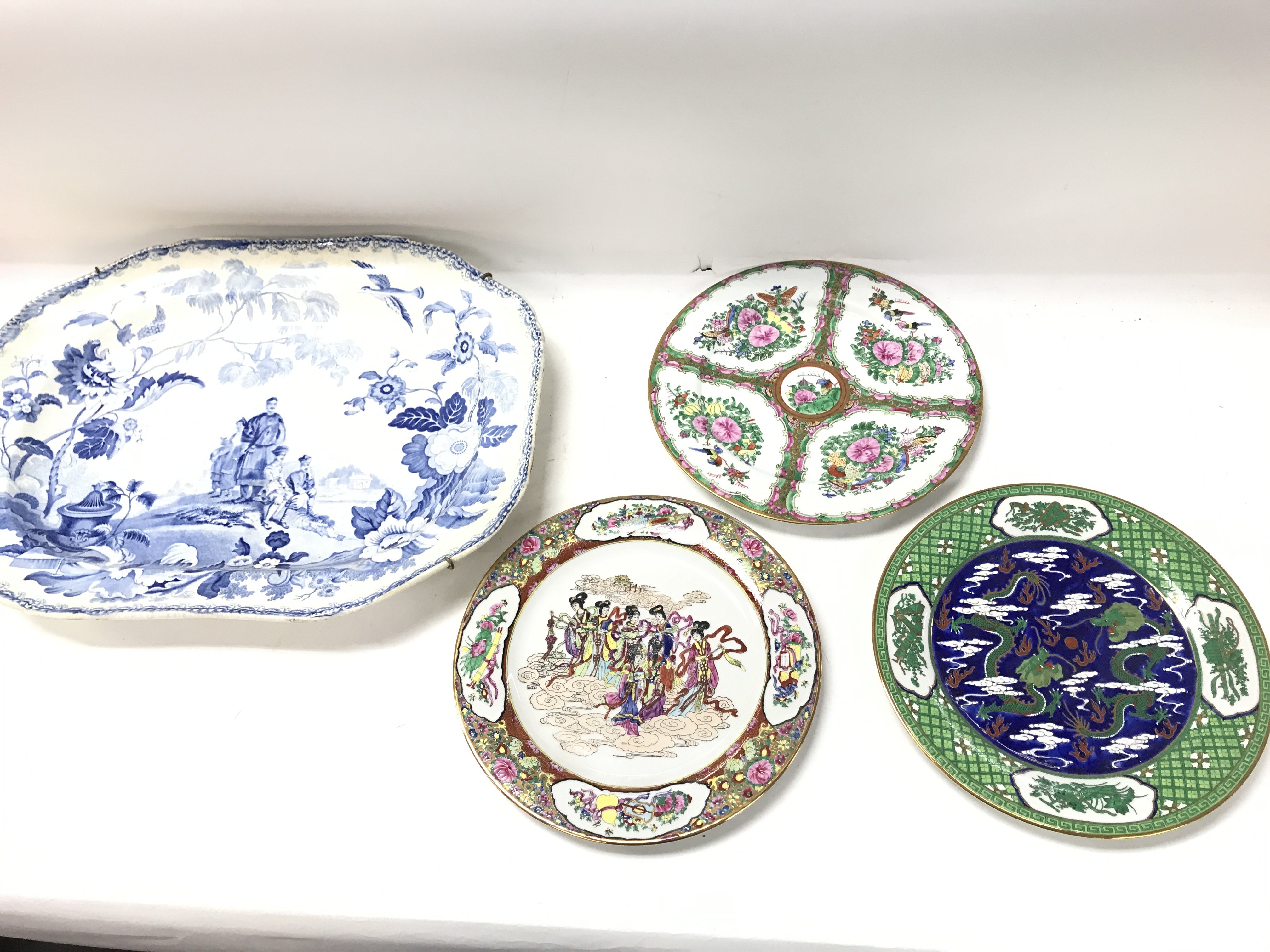 A collection of plates including a large blue and white serving plate.