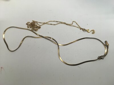 A 585 stamped chain with an 's' pendant and another 9ct gold chain. Approx weight 3.42 grams.