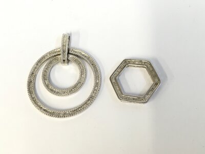 Two silver pendants.