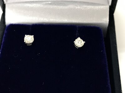 A pair of 18ct white gold solitaire diamond studs approximately 0.30ct.
