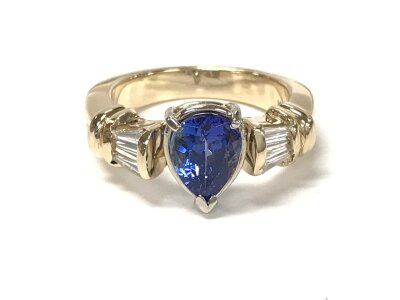 14ct gold ring set with pear shaped tanzanite and baguette cut diamonds in shoulders. With cert. Size P