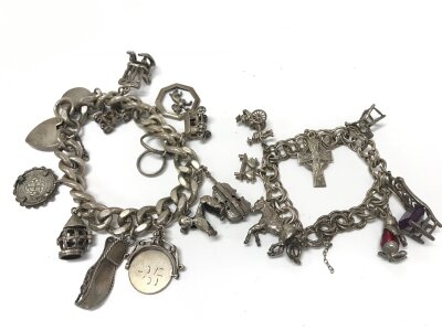 Two silver charm bracelets with assorted charms. 129.81g