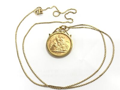 A 1964 sovereign in a 9ct gold scrole mount on a 22 inch 18ct gold box link chain , 13.6g total weight