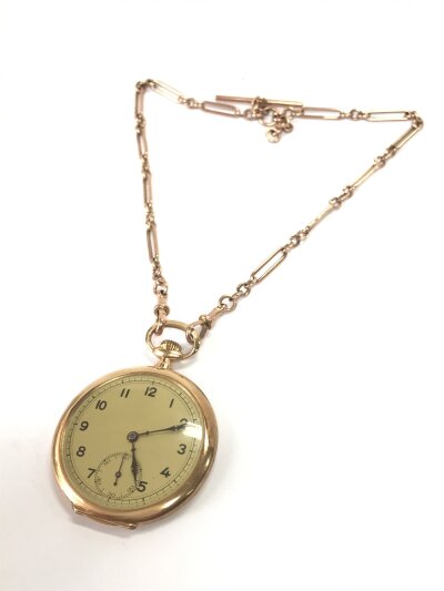 A Gents open face evening pocket watch with a 19 jewelled lever Swiss movement with micra regulator adjustment and standard gold marks no 243. Engine turned back to case. With a double Albert of fetter and three link design with two swivels stamped 9ct. 63g total weight