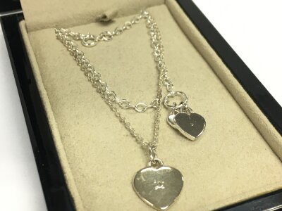 A silver and diamond necklace and bracelet hearts set. 6.8g total weight