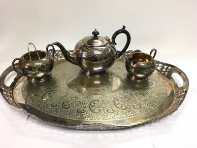 A large silver plated tray, width approx 56cm and a silver plated three piece tea service.
