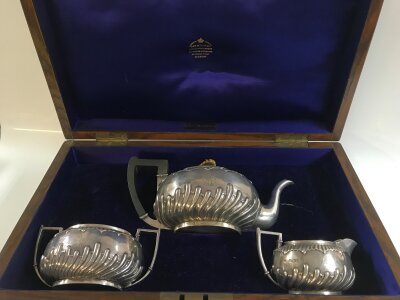A cased silver hallmarked three piece tea set with London hallmarks retailed by J&W Mitchell Glasgow. Total weight 580g approx