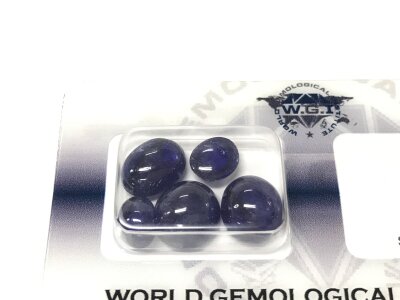 Certified and sealed parcel of 5/cabochon glass filled sapphires totalling 20.97ct.