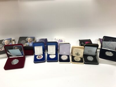 A collection of 7 assorted silver proof coins including sterling and pure silver.