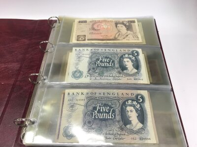 A folder of British and other world banknotes.