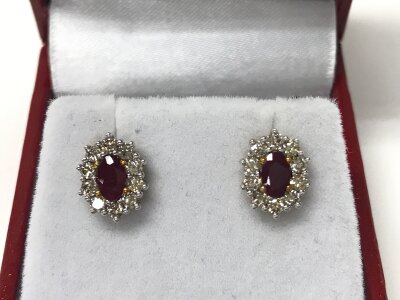 A pair of 9ct yellow and white gold oval Ruby and diamond cluster studs. Rubies 0.62ct and diamonds 0.51ct