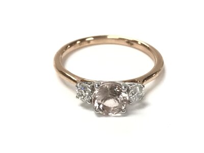 A 9ct rose gold trilogy ring set with central round cut morganite flanked by diamonds. Size O