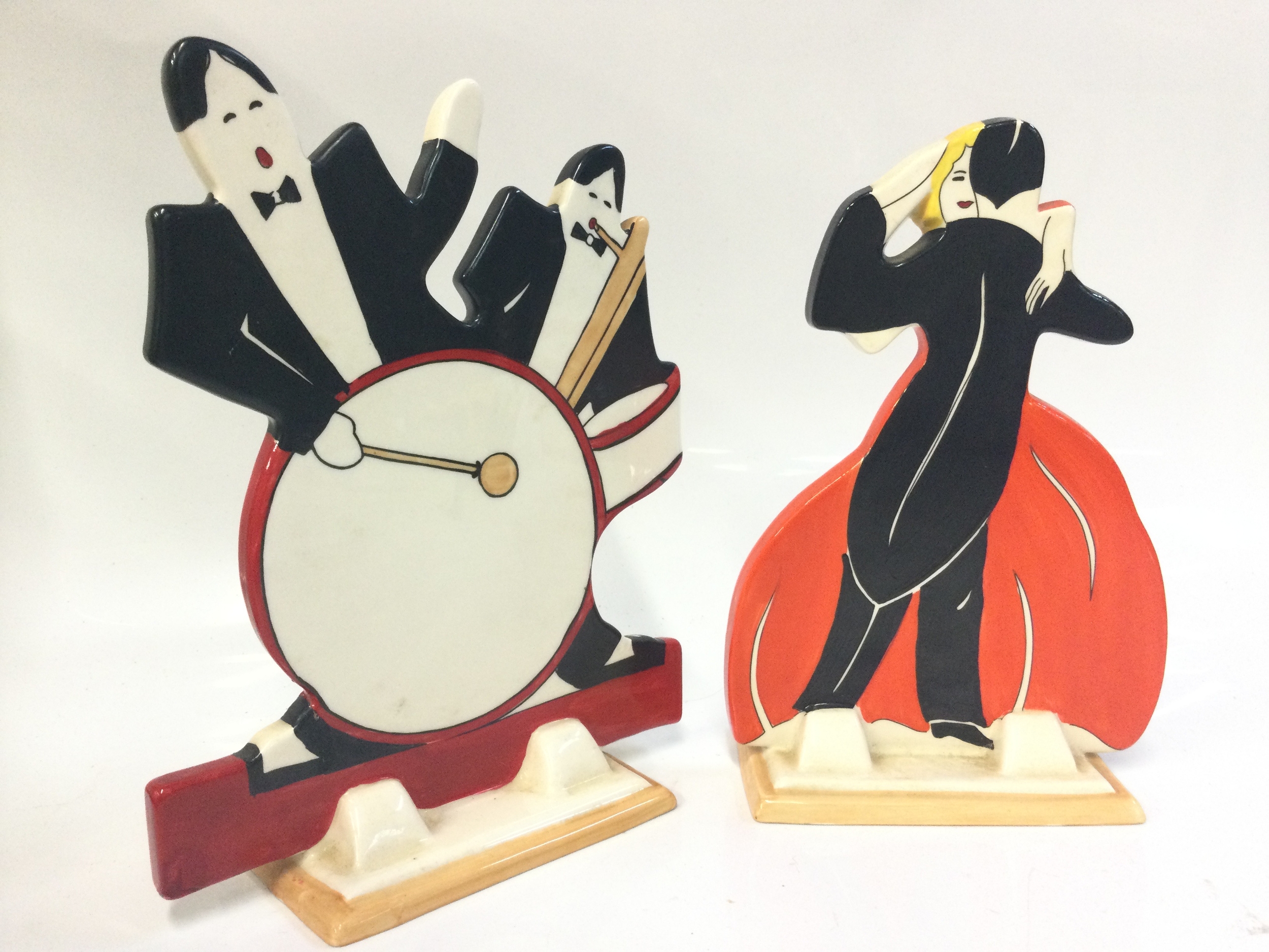 Wedgwood reproduction Age of Jazz Clarice Cliff Bizarre porcelain figures, Man With A Drum and a Dancing Couple. Dancers signed Pauline a Tomlinson and Elizabeth Shaw. Damage and restoration on the drummer figure, 19 and 20cm tall NO RESERVE