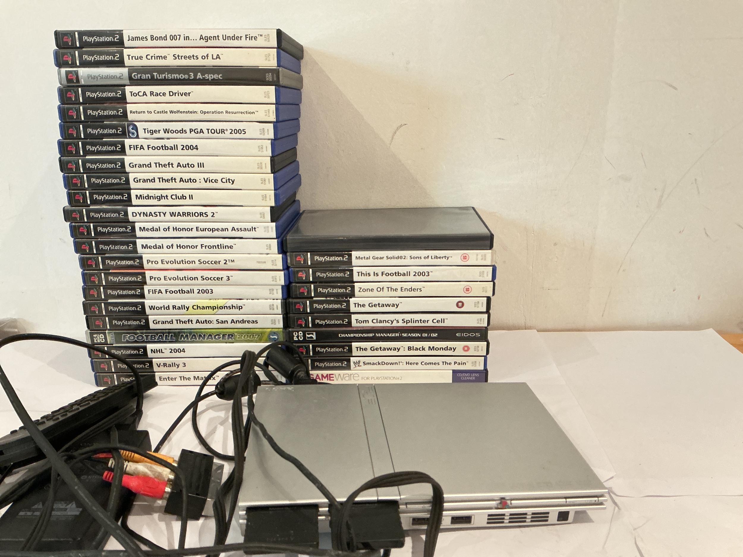 A PlayStation 2 Slim With A Collection Of Games. No Reserve.