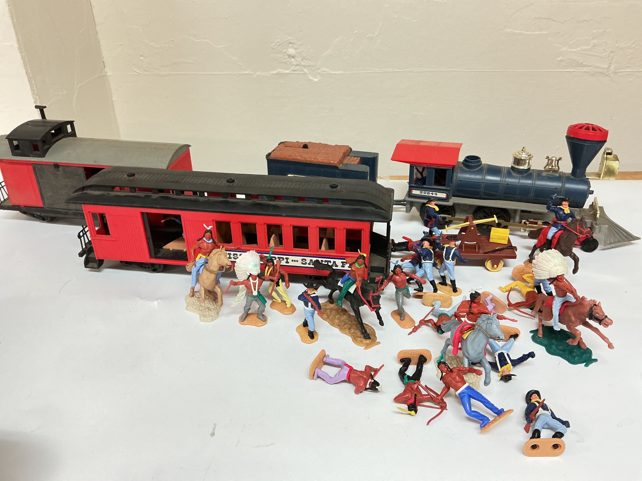 A Timpo Prarie Locomotive With Track and Railcar And 7th Cavalry And Indian Figures.