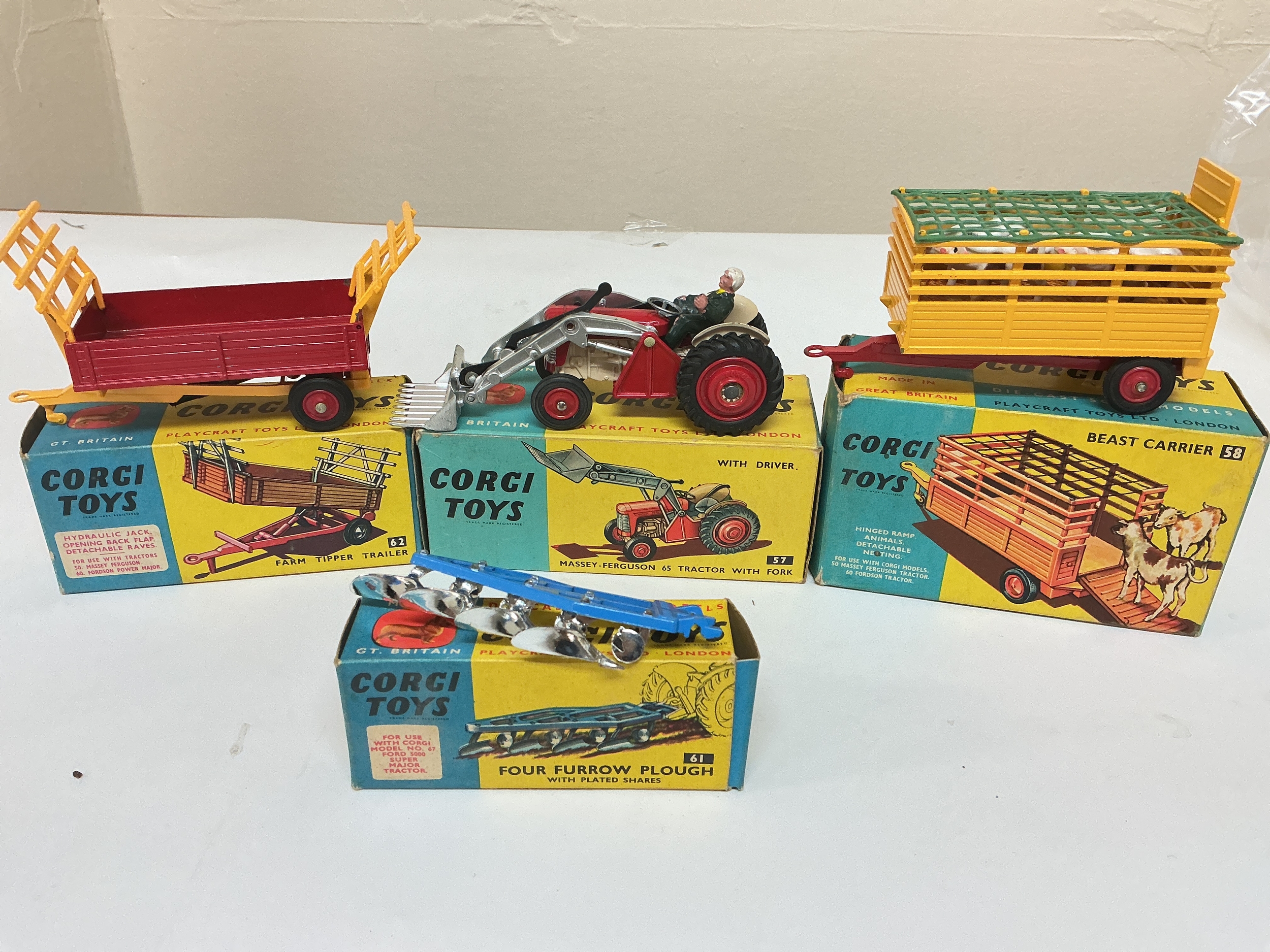 A Boxed Corgi Massey-Ferguson 65 Tractor With Fork #57, A Farm Tipper Trailer #62, A Beast Carrier #58 And A Four Furrow Plough #61.