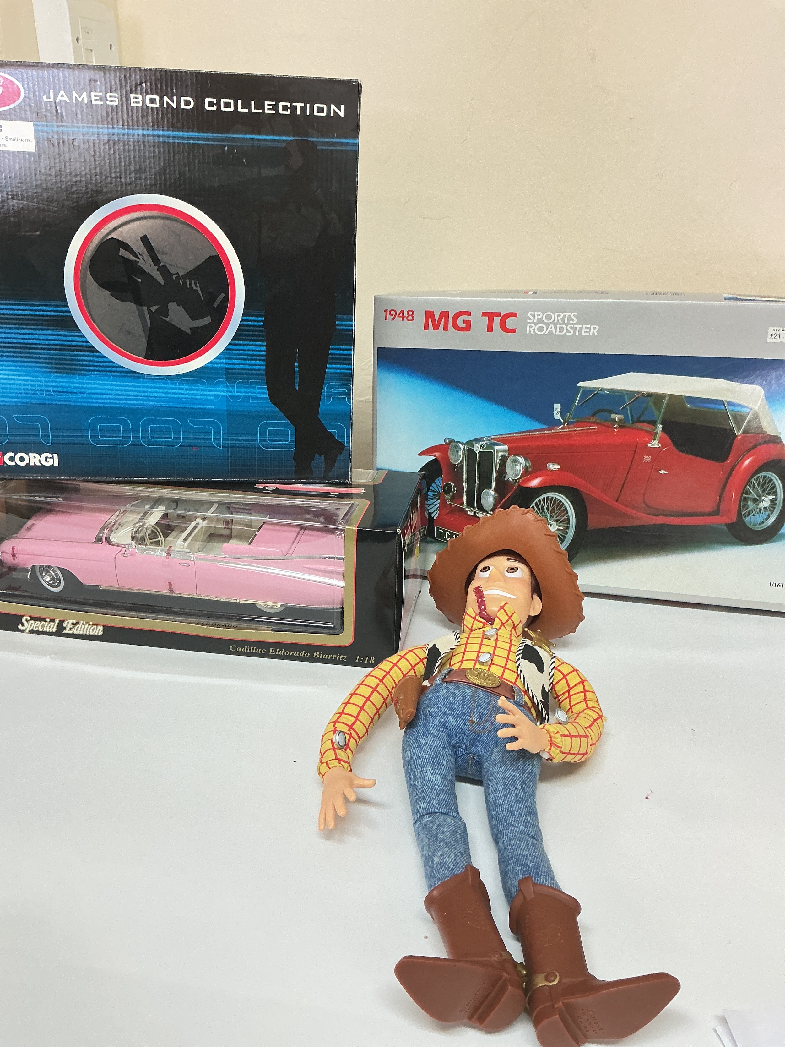 A Boxed Corgi James Bond Collection Set, A Academy 1948 MG TC 1/16 Scale, A Toy Story Woody Figure And A Maidstone Cadillac Eldorado Biarritz 1/18 Scale. No Reserve.