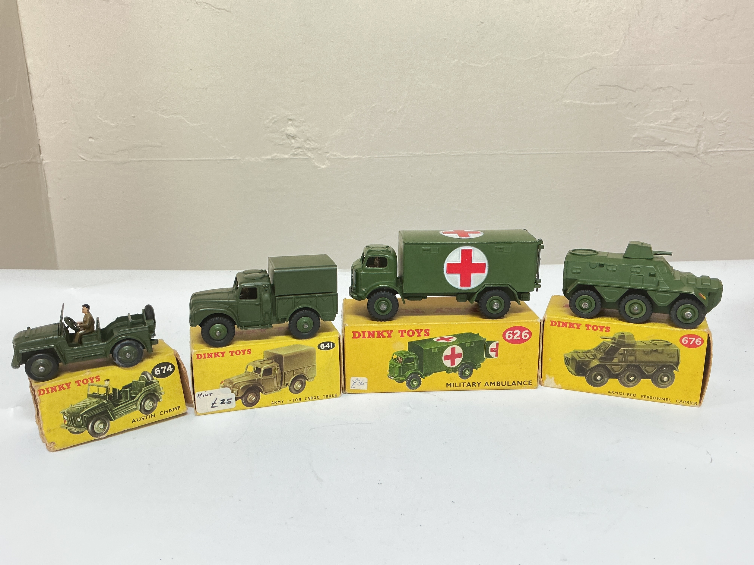 4 X Boxed Dinky Military Vehicles, A Austin Champ #674, A Army 1-Ton Cargo Truck #641, A Military Ambulance #626 And A Armoured Personnel Carrier #676. No Reserve.