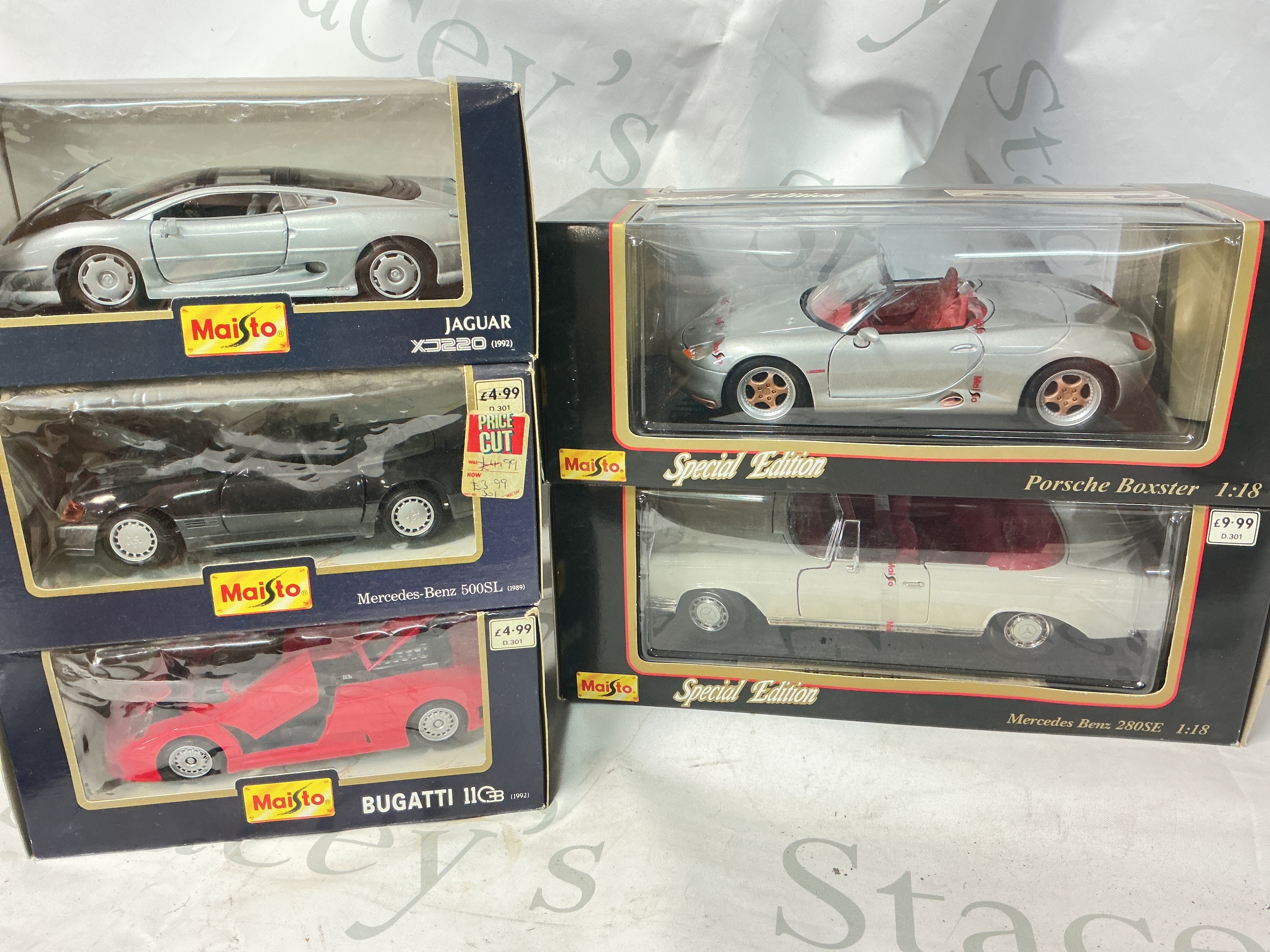 A Boxed Maisto 1/18 Scale Porsche Boxster, A 1/18 Scale Mercedes-Benz 280SE, A 1/24 Scale Jaguar XJ220, A Mercedes-Benz 500SL 1/24 Scale And A Bugatti EB110 1/24 Scale. No Reserve.