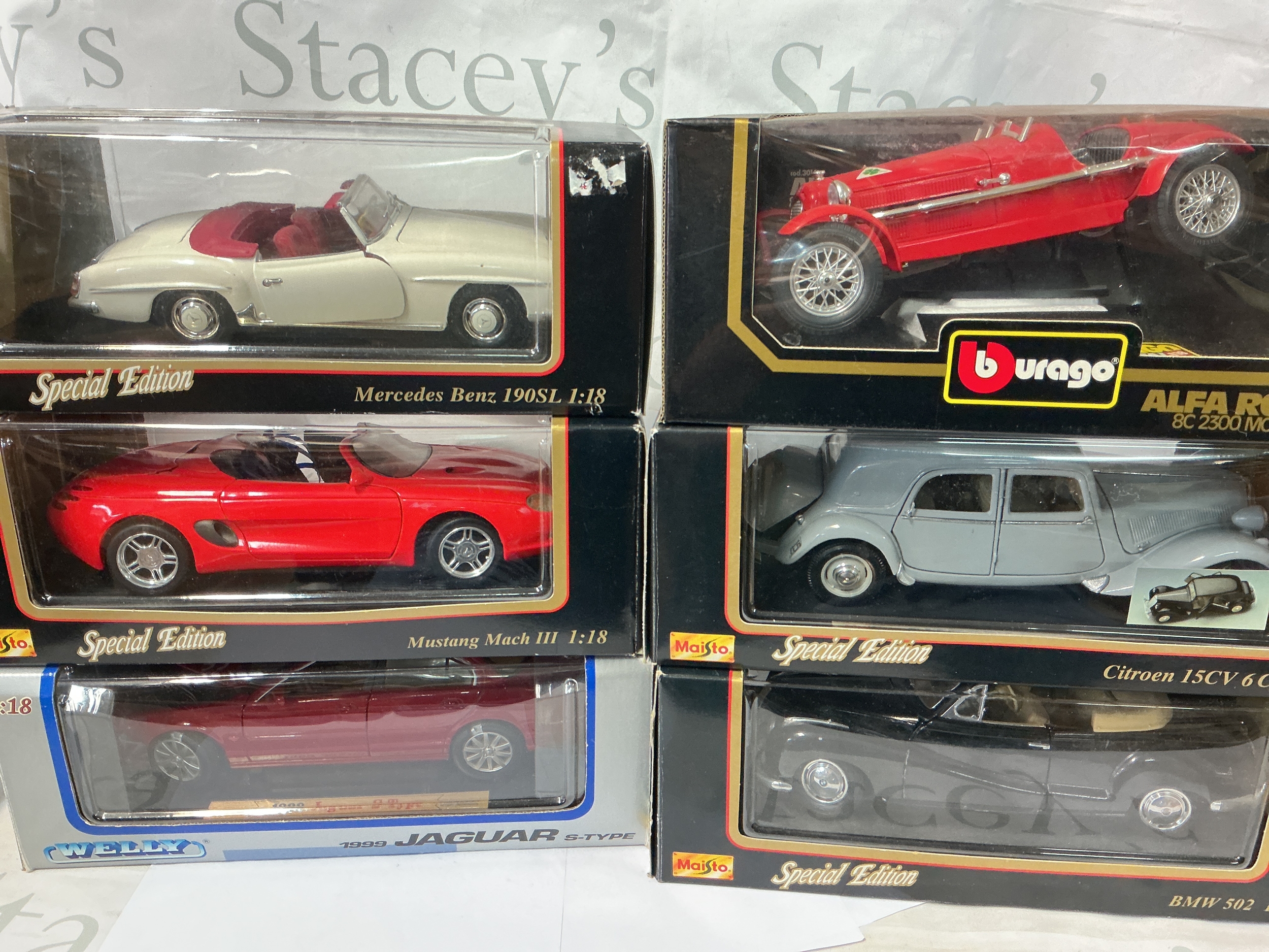 A Collection Of 6 Boxed Maisto, Burago And Welly 1/18 Scale Diecast Including Mercedes Benz, Mustang, Jaguar, Alfa Romeo, Citroen And BMW. No Reserve.