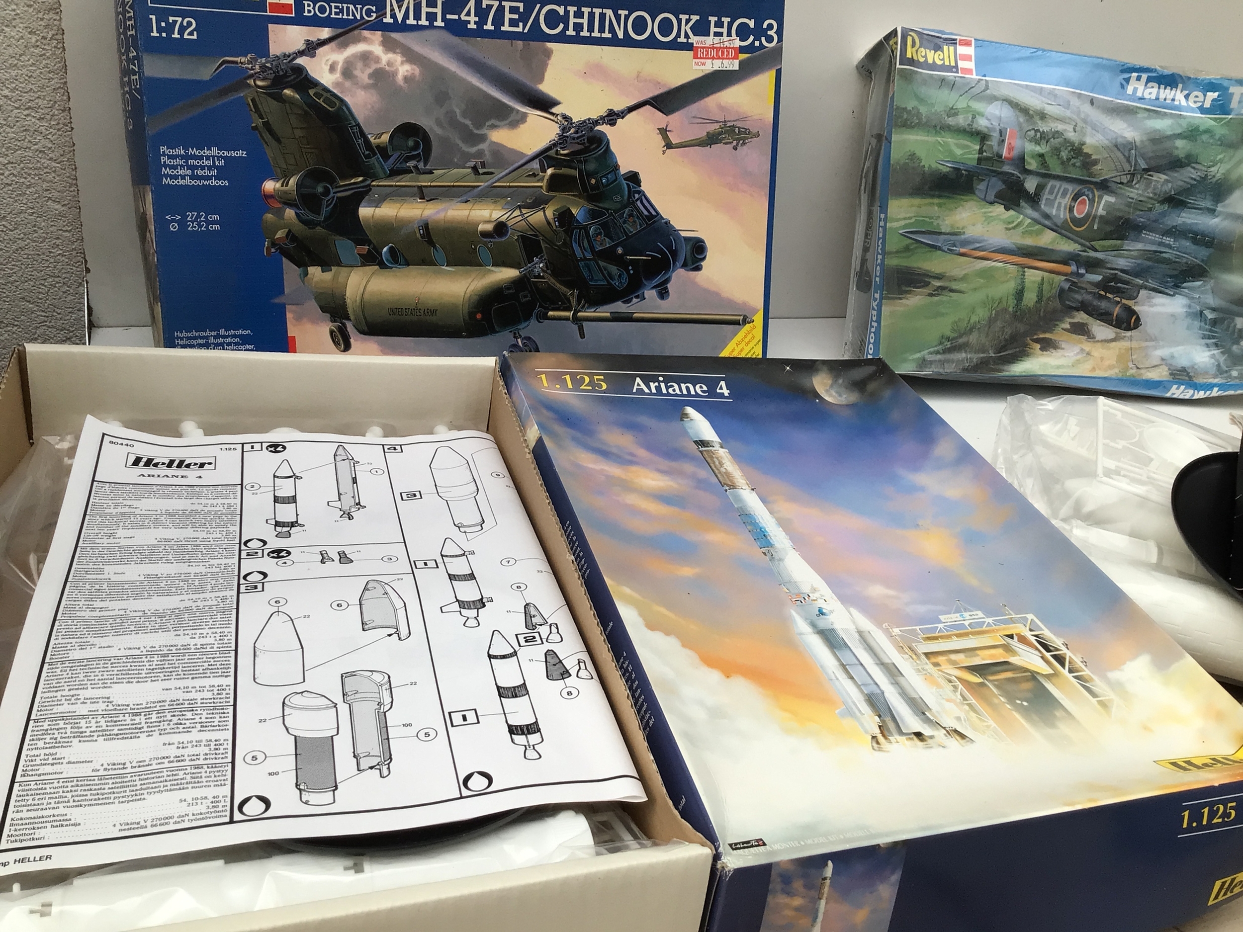 A collection of boxed model kits by Revell, Heller.  Comprising military aircraft and US space rockets.  In a variety of scales.  No reserve