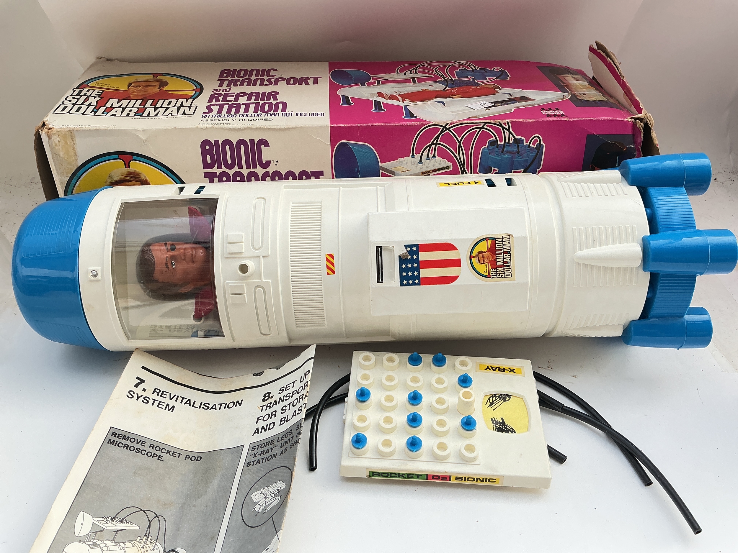 A Boxed Denys Fisher Six Million Dollar Man Bionic Transport With Figure. Box Is Worn.