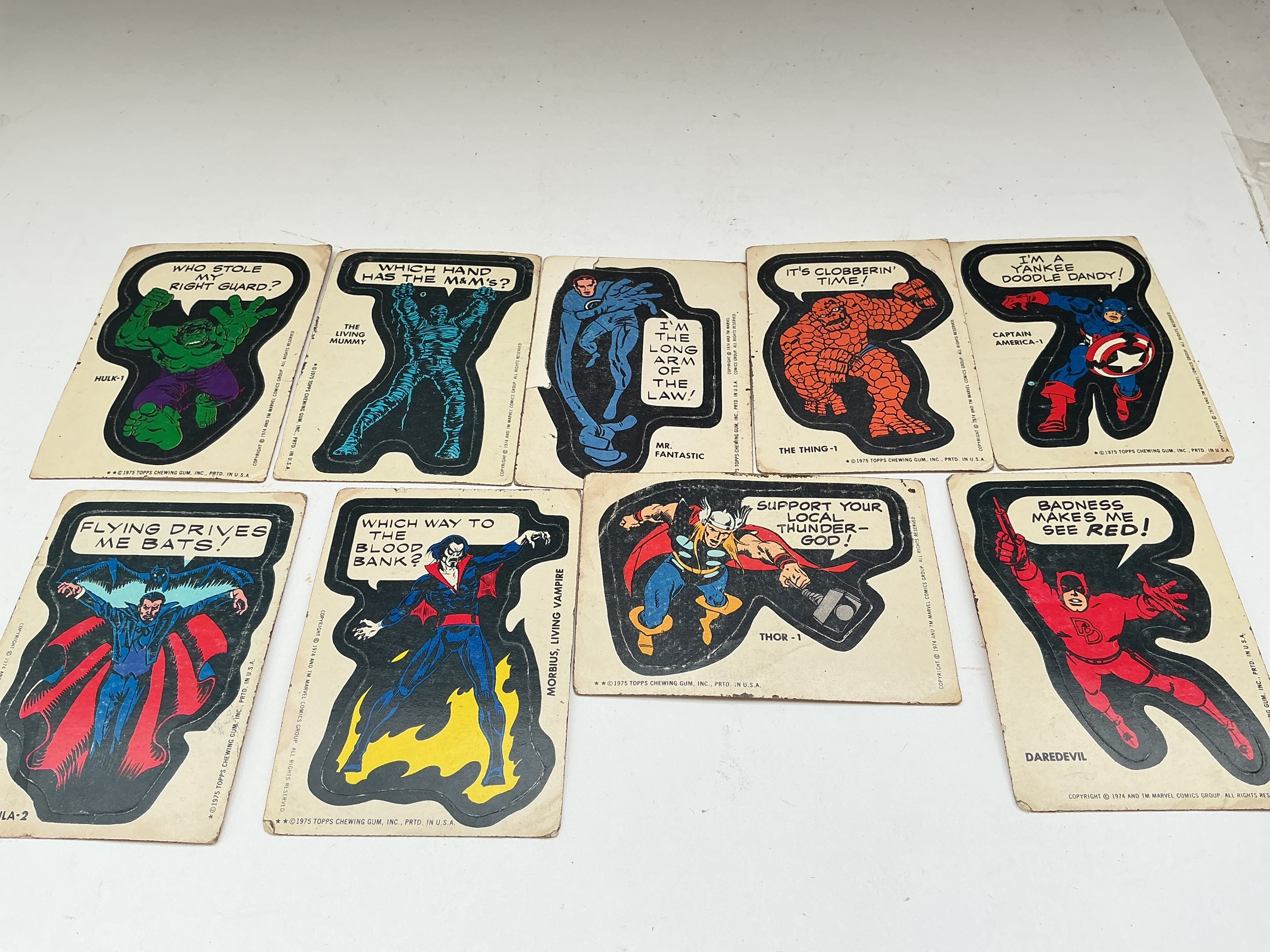 A Collection Of 9 1975 Topps Marvel Comic Book Hero Stickers