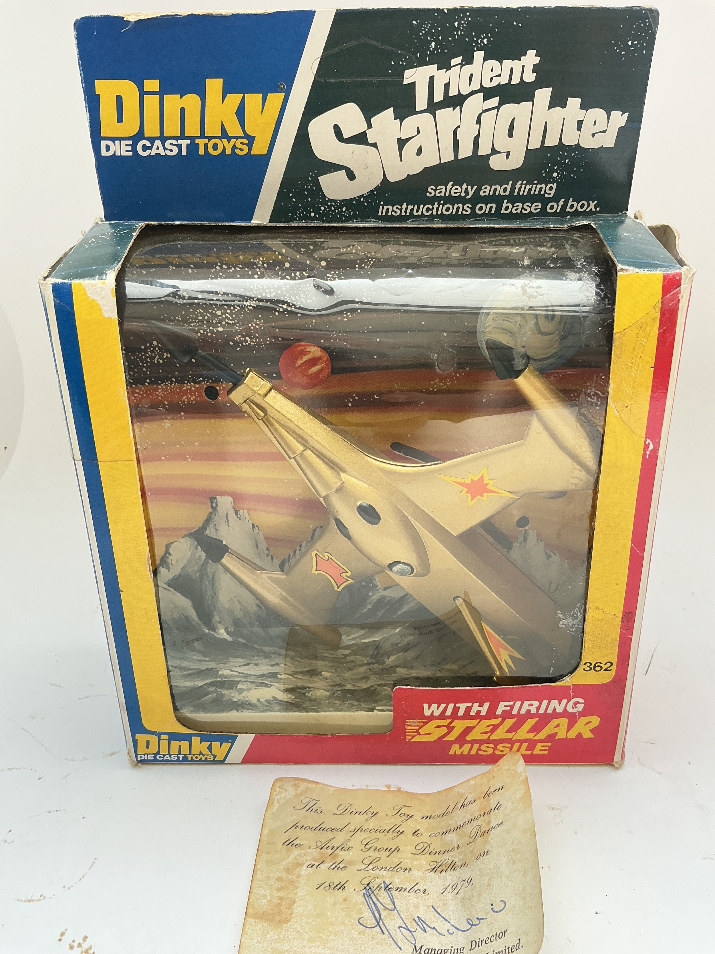 A Rare Dinky Toys Boxed Trident Starfighter In Gold Colour. This Dinky Toy Model Was Produced Specially To Commemorate The Air Fix Group Dinner Dance At London Hilton On The 18th September 1979. Comes With Certificate Signed By The Meccano Managing Director.